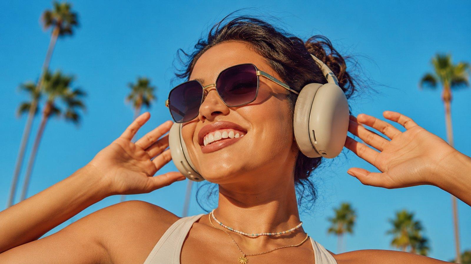 Wearing oversized Nxtedit sunglasses and headphones under palm trees