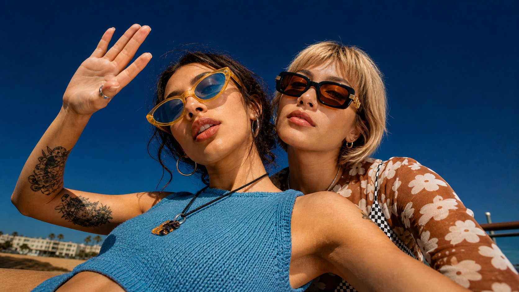Two people wearing edit sunglasses against a deep blue sky, edit sunglasses